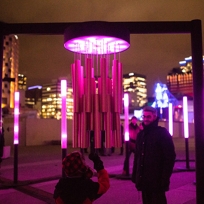People looking at the Chimes Art Installation